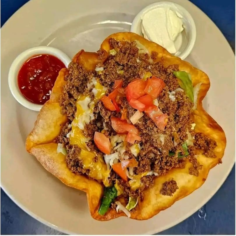 A Mi Tierra Mexican taco salad in a crispy fried shell with ground beef, cheese, and tomatoes.
