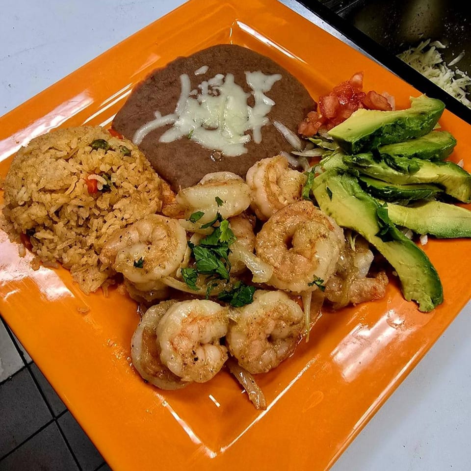 Mi Tierra Mexican Grill's shrimp fajita plate with rice, refried beans, avocado, and pico de gallo.